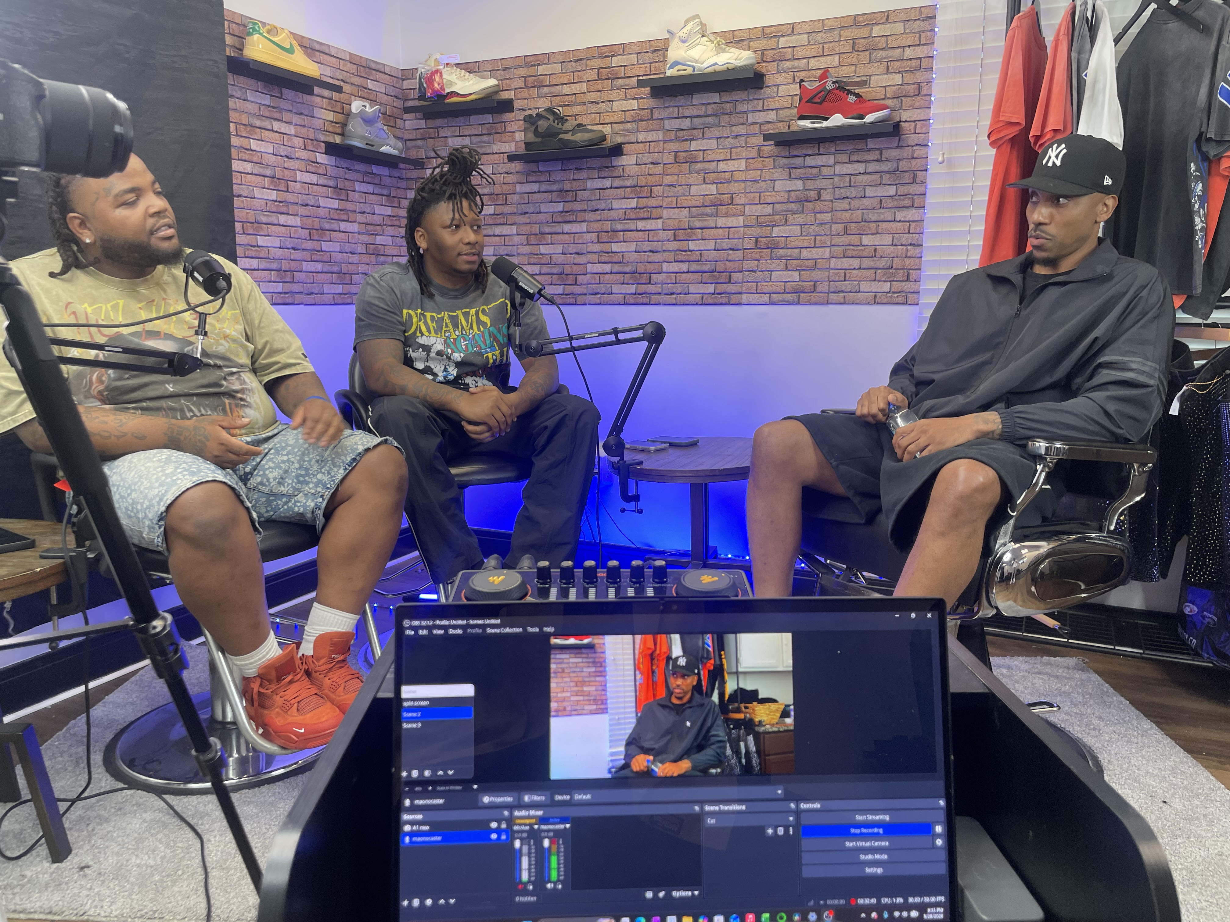 Alpha Generation Media on set during a podcast build-out with Jeff Teague, hosts seated at the mic table in the sneaker studio